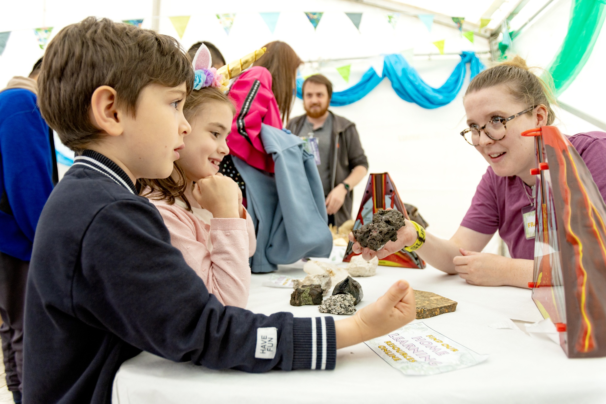 A University staff member talking with young people in the University of Bristol marquee at the Festival of Nature 2024